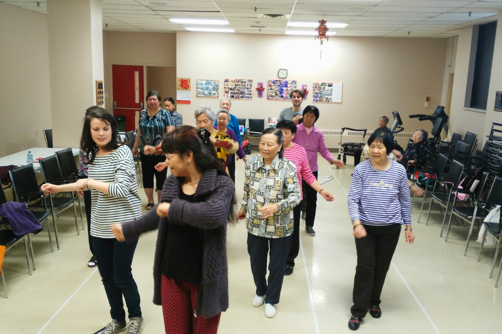A group of older adults participating in a theatre workshop.